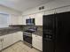 Bright kitchen features modern appliances, white cabinets, and granite countertops at 1806 Renada Cir, North Las Vegas, NV 89030