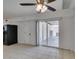 This living room features neutral tile flooring and a ceiling fan at 1806 Renada Cir, North Las Vegas, NV 89030