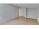 A well-lit living room with ceramic tile floors, and a built in closet at 1806 Renada Cir, North Las Vegas, NV 89030