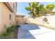 This large backyard features a covered patio, mature plants, and a privacy wall at 1904 Imola Ct, Las Vegas, NV 89123