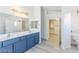 Bathroom features double sinks, tile backsplash, with an entryway into a walk-in closet at 1904 Imola Ct, Las Vegas, NV 89123