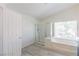 Well-lit bathroom with a shower, tub, and large window providing natural light at 1904 Imola Ct, Las Vegas, NV 89123