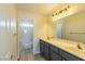 Well-lit bathroom features dual sinks, modern fixtures, and a shower-tub combination at 1904 Imola Ct, Las Vegas, NV 89123