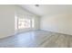 Bright bedroom features wood-look floors and a large window with a neighborhood view at 1904 Imola Ct, Las Vegas, NV 89123