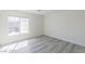 Bright bedroom featuring wood-look flooring and a large window letting in natural light at 1904 Imola Ct, Las Vegas, NV 89123