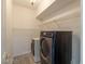 Bright laundry room features modern appliances and wire shelving at 1904 Imola Ct, Las Vegas, NV 89123