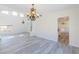 Spacious living room boasts high ceilings, wood-look floors, and elegant chandelier lighting at 1904 Imola Ct, Las Vegas, NV 89123