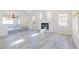 Open living room featuring a fireplace and light gray vinyl floors at 1904 Imola Ct, Las Vegas, NV 89123