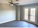 Bedroom features gray vinyl flooring and glass patio doors at 1967 N Moapa Valley Blvd, Logandale, NV 89021