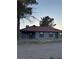 The exterior features a chain link fence around the yard and tile roof at 1967 N Moapa Valley Blvd, Logandale, NV 89021