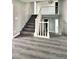 Entrance foyer with wooden stairs, updated flooring, and access to the second story at 1967 N Moapa Valley Blvd, Logandale, NV 89021