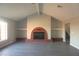 Bright living room with a vaulted ceiling, fireplace, and gray vinyl floors at 1967 N Moapa Valley Blvd, Logandale, NV 89021