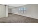 Large bedroom with three windows, carpet, and mirrored closet at 2080 Karen Ave # 12, Las Vegas, NV 89169