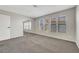 Comfortable bedroom with neutral carpet, windows with privacy blinds, and mirrored closet at 2080 Karen Ave # 12, Las Vegas, NV 89169