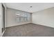 Spacious bedroom with neutral carpeting, large windows with privacy blinds, and mirrored closet at 2080 Karen Ave # 12, Las Vegas, NV 89169
