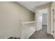 Upstairs hallway with carpeted floors, white railing, and access to bedrooms at 2080 Karen Ave # 12, Las Vegas, NV 89169