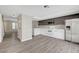 Bright kitchen with modern appliances, white cabinets, gray accent cabinets, and wood-look flooring at 2080 Karen Ave # 12, Las Vegas, NV 89169