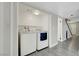 Functional laundry room with modern washer and dryer, shelving, and convenient access to stairs at 2080 Karen Ave # 12, Las Vegas, NV 89169