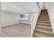 Open concept living area with staircase, updated floors, and kitchen pass-through at 2080 Karen Ave # 12, Las Vegas, NV 89169
