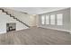 Open concept living room with new floors, neutral paint, staircase and view of the courtyard at 2080 Karen Ave # 12, Las Vegas, NV 89169