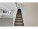 Carpeted staircase with white railing, leading to the upper level, adjacent to kitchen at 2080 Karen Ave # 12, Las Vegas, NV 89169