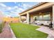 Spacious backyard with well-maintained artificial grass, patio, and privacy wall at 2450 Amatrice St, Henderson, NV 89044