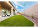 Beautiful backyard with lush artificial grass and an inviting outdoor seating area at 2450 Amatrice St, Henderson, NV 89044