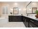 Bright bathroom featuring dual sinks, dark wood cabinets, white countertops, and a separate soaking tub at 2450 Amatrice St, Henderson, NV 89044