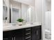 Bathroom featuring double sink vanity with white countertop and dark cabinets at 2450 Amatrice St, Henderson, NV 89044