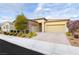 Lovely single-story home features a two-car garage, a stone facade, and a paved driveway at 2450 Amatrice St, Henderson, NV 89044
