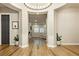 An inviting home foyer featuring wood flooring, a decorative lighting fixture and arched entryway at 2450 Amatrice St, Henderson, NV 89044