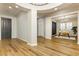 A modern foyer with wood-look floors leading to an office space and a large dining area at 2450 Amatrice St, Henderson, NV 89044