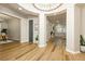 An elegant home entrance featuring wood flooring, circular lighting and archways to other rooms at 2450 Amatrice St, Henderson, NV 89044