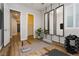 Bright home gym with a yoga mat, free weights, large mirrors, and a glimpse into the home's hallway at 2450 Amatrice St, Henderson, NV 89044