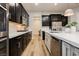 A modern kitchen showcasing stainless appliances, white countertops, and stylish cabinetry at 2450 Amatrice St, Henderson, NV 89044