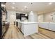 Contemporary kitchen with stainless steel appliances, white countertops and an island with a seating area at 2450 Amatrice St, Henderson, NV 89044