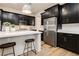 Bright kitchen with stainless steel appliances, modern lighting and a kitchen island with seating at 2450 Amatrice St, Henderson, NV 89044
