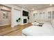 Inviting living room with a fireplace, a white shiplap wall, ample seating, and plantation shutters for natural light at 2450 Amatrice St, Henderson, NV 89044