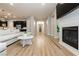 Spacious living room with modern flooring, a fireplace, a large sectional couch and an open concept design at 2450 Amatrice St, Henderson, NV 89044