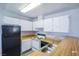 Kitchen featuring white cabinets, wooden countertops and black appliances at 2755 Jennydiane Dr, Las Vegas, NV 89121