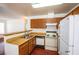 Kitchen featuring wood cabinets, white appliances, and wood countertops at 2755 Jennydiane Dr, Las Vegas, NV 89121