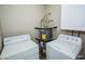 A laundry room featuring both a washer and a dryer, as well as a water heater at 2755 Jennydiane Dr, Las Vegas, NV 89121