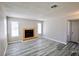 A well-lit living room featuring a fireplace and sleek gray hardwood flooring at 2755 Jennydiane Dr, Las Vegas, NV 89121