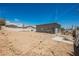 View of the rear of the building and rear yard featuring a stucco exterior and gravel ground cover at 2807 Hermosa St, Las Vegas, NV 89169