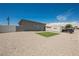 This backyard features gravel, a small patch of grass, a PODS moving container, and a view of the house at 2807 Hermosa St, Las Vegas, NV 89169