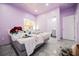 Bright bedroom featuring tiled floor, updated lighting, and an en-suite bathroom at 2807 Hermosa St, Las Vegas, NV 89169