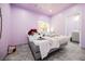 Bright bedroom featuring tiled floor, updated lighting, and an en-suite bathroom at 2807 Hermosa St, Las Vegas, NV 89169