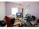 A bedroom features lilac walls with cluttered chair, tables, office equipment and computer at 2807 Hermosa St, Las Vegas, NV 89169