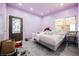 Bedroom featuring gray floors, a modern bedframe, ample natural light, and a decorative glass-paneled door at 2807 Hermosa St, Las Vegas, NV 89169