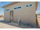 View of rear of the building and rear yard featuring a security door, stucco exterior and gravel ground cover at 2807 Hermosa St, Las Vegas, NV 89169